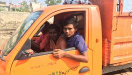 Chandu, 20 (in blue t-shirt), a rag picker from Bihar who works at Eco Green Energy earning about Rs. 200-300 per day.