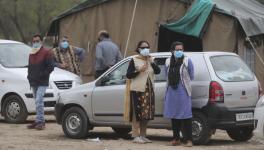 Doctors wear masks and stand outside isolation wards set up for possible COVID-19 patients in Jammu. 