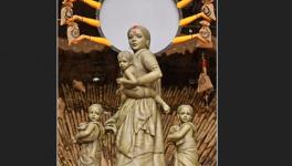 Sculpted tableau of Durga and her children as a migrant worker family