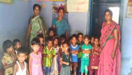 Anganwadi helper Mohammad Mahboobi (left) with worker Sridevi and a child’s mother in Pacharla village, in the Jogulamba Gadwal district of Telangana.