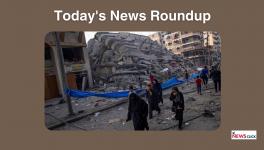 Palestinians walk by the rubble of a building after it was struck by an Israeli airstrike, in Gaza City, Sunday, Oct. 8, 2023. 