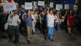 Journalists take part in a candle march against Police raid on news portal NewsClick, in Mumbai on Thursday. 