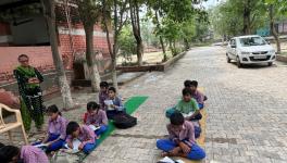 Classrooms being held under a tree at the government school in Kasandi.