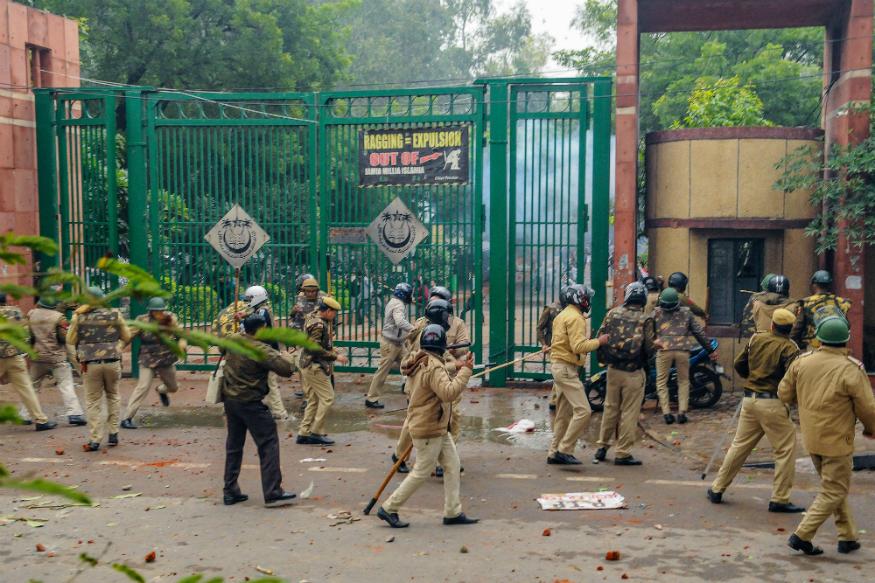 Police personnel outside the Jamia Millia Islamia University as students stage a protest against the passing of Citizenship Amendment Bil