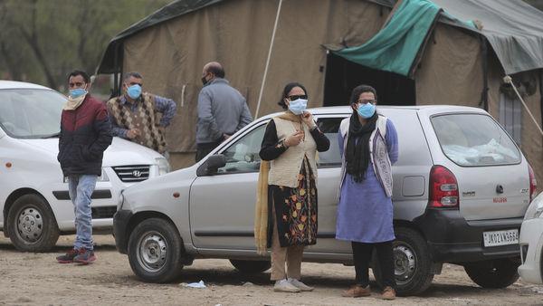 Doctors wear masks and stand outside isolation wards set up for possible COVID-19 patients in Jammu. 