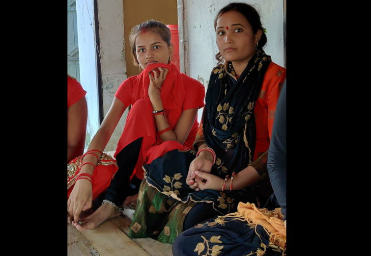 Mandakini with her sister in red suit with black stole on right side.