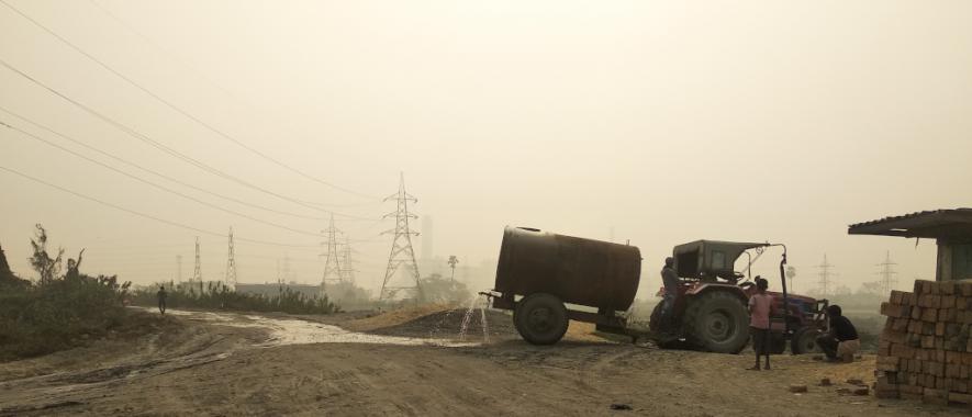 Water sprinkling on a fly ash ridden road