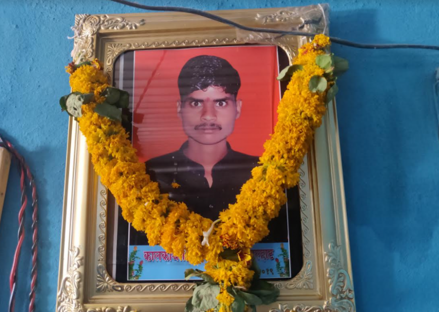 Garlanded photo of Chetan Alhat