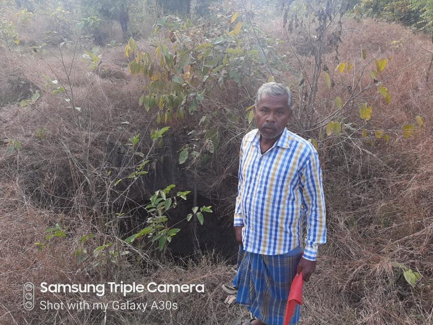 Farmer stands inside the fenced area