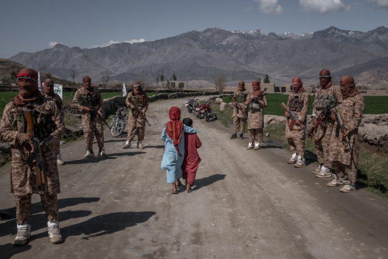 Afghan children walk past a Taliban Red Unit, an elite force, Alingar district, Laghman province in eastern Afghanistan (File photo) 