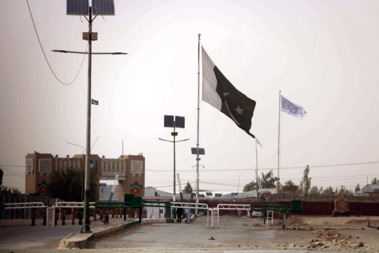 Flag of Afghan Taliban (in white) was raised on the Afghan side of the border with Pakistan at the major border crossing at Chaman, 14 July 2021.