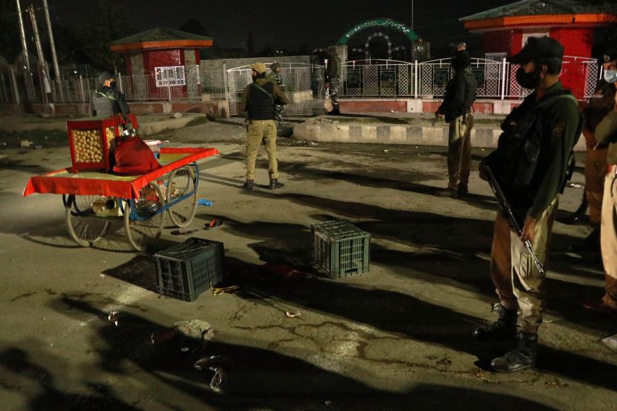 Goverment Forces standing near the cart of the vender Arbind Kumar a Non local vender who was killed by suspected militants at Eidgah Srinagar. Photo by Kamran Yousuf