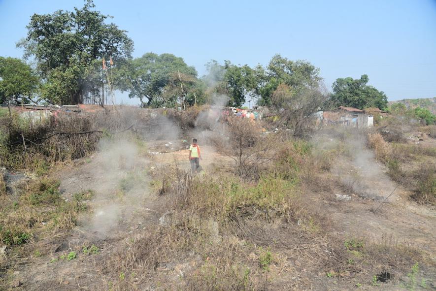 Smoke billowing from underground fires right behind settlements in Jairamdih village of Dhanbad district