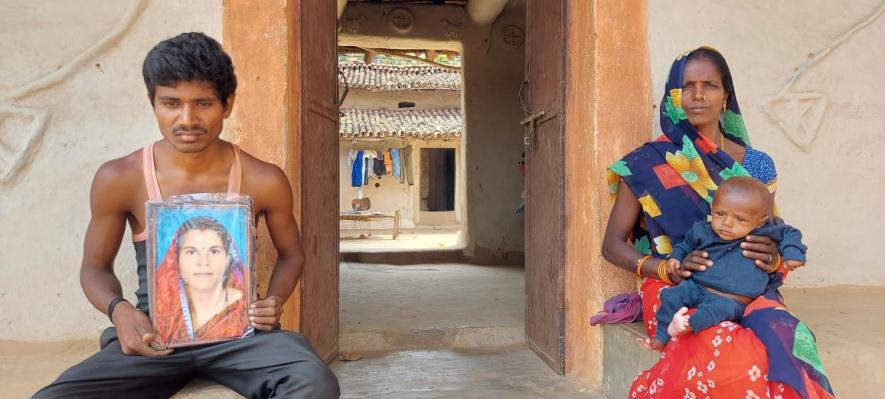 Ajay's mother Phoolmati feeding her grandson whose mother Pratibha passed away soon after his birth. ​