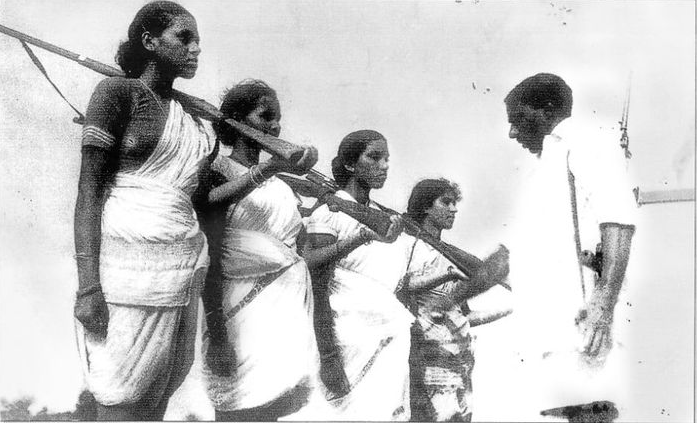 Swarajyam (extreme left) and other members of an armed squad (Dalam) being inspected during the Telangana armed struggle. (Photograph by Sunil Janah/Prajasakti Publishing House)