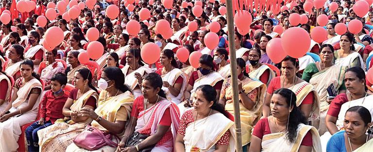 Women waiting to receive the flag post procession.