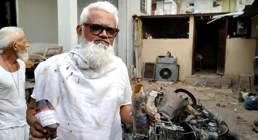 Nasir and his elder brother Bahseer at showing the petrol bombs thrown at his house