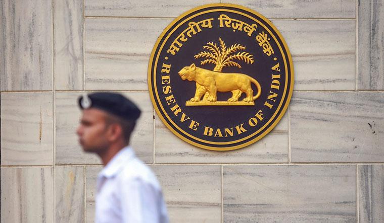 A security person walks past the RBI Headquarters in Mumbai on Monday ahead of a crucial board meeting