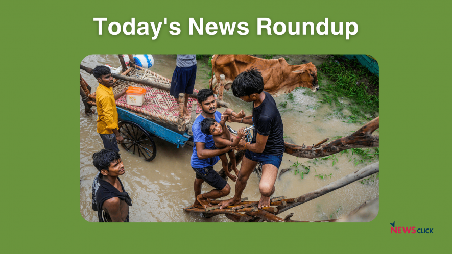 People from low-lying areas around the Yamuna river help one another relocate to a safer place after their houses were submerged in the swollen river, in New Delhi, Wednesday, July 12, 2023. 