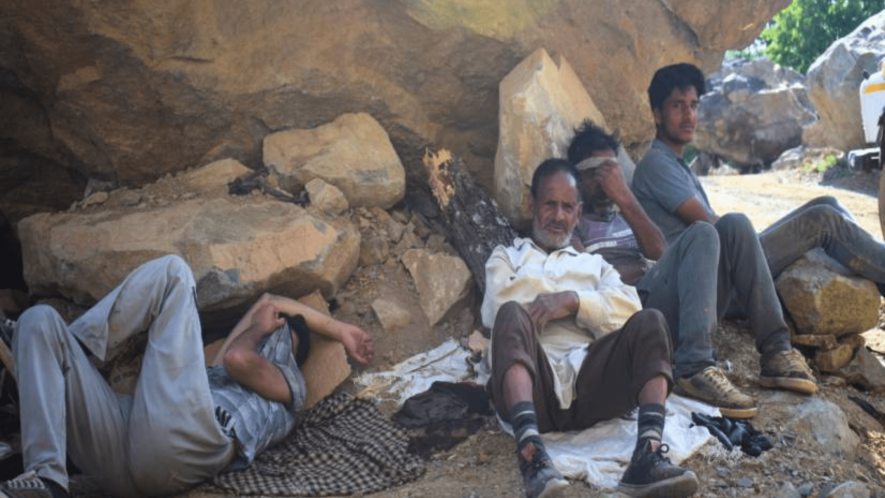 Workers at a stone quarry in Baramulla take a moment to rest, shelter against the scorching summer heat (Photo - Suhail Khan, 101Reporters).