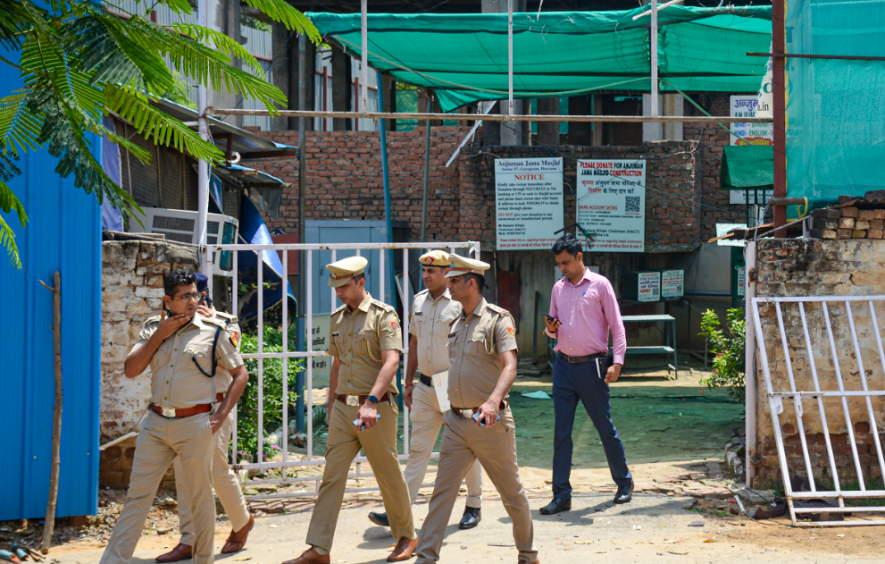 Police personnel outside Anjuman Mosque which was set ablaze in the Sector 57 area, in Gurugram district, Tuesday, Aug. 1, 2023.