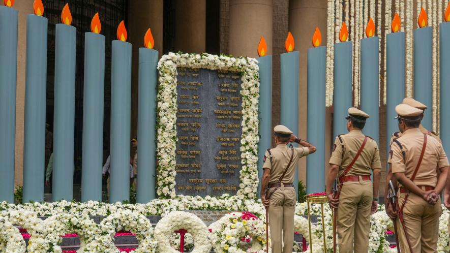 Police personnel pay tribute to the martyrs who laid down their lives while fighting terrorists during 26/11 attack, on its 15th anniversary in Mumbai, Sunday, Nov. 26, 2023.