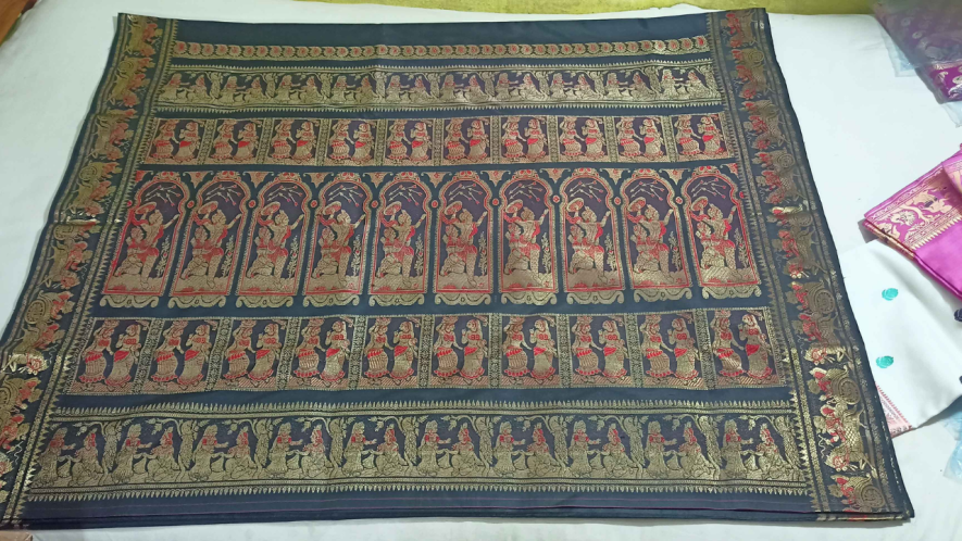 Small trader Raju Pal showing Baluchari sarees in his shop in Vaishnabpara