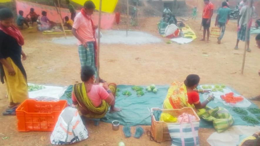 Men are engrossed in the sport while women use the event as an avenue to sell their produce