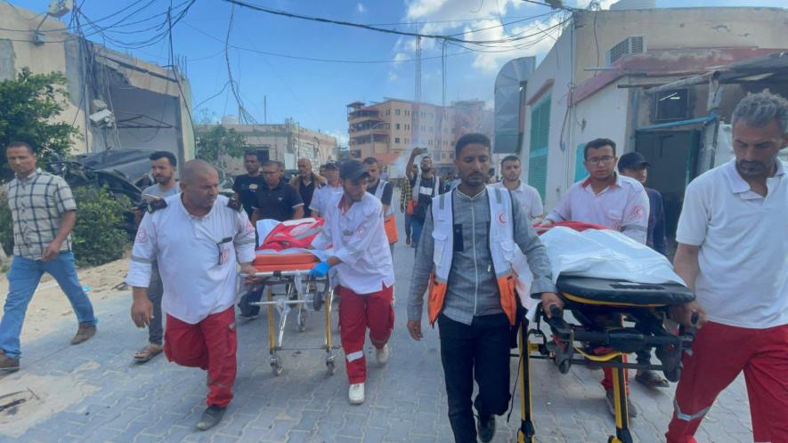 Palestinian Red Crescent crews mourn fellow paramedics Haitham Tubasi and Suhail Hassouna, killed by Israeli forced (Photo via PRCS)