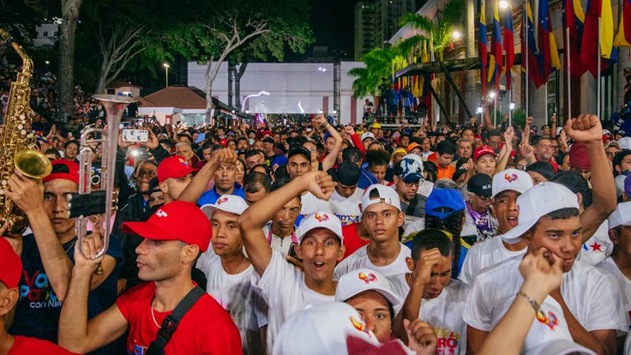 People in Caracas, Venezuela cheer on Nicolás Maduro's speech on victory night outside Miraflores palace. (Photo: Zoe Alexandra)