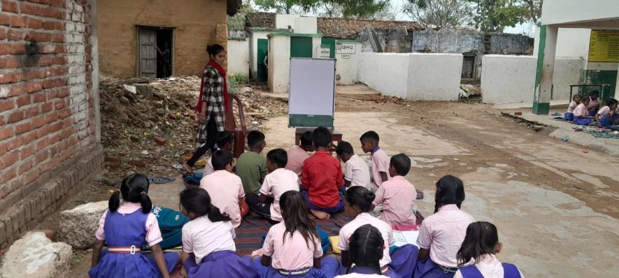Students_are_studying_on_the_verandah_after_demolition_of_classrooms.