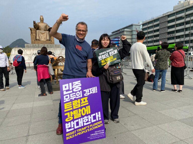 The author with a young Korean activist in front of the US embassy and King Sejong. Photo: Vijay Prashad