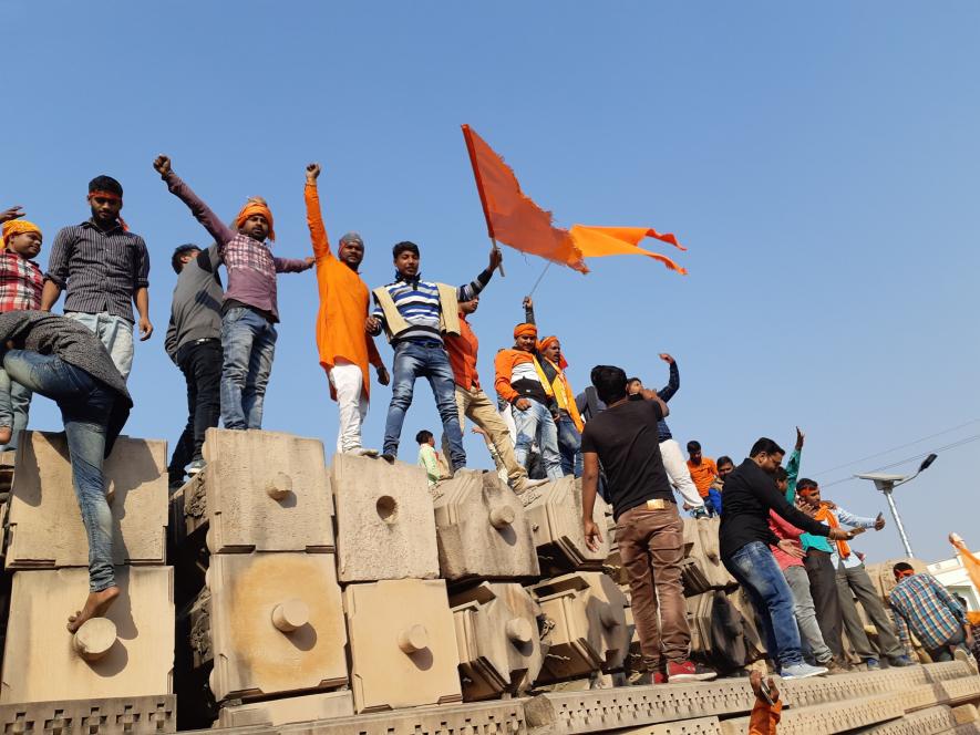 Ram%20temple%20belivers%20standing%20at%20the%20stones%20with%20saffron%20flag%20and%20chanting%20religious%20slogans%20in%20Ayodhya.%20Photo%20by%20Saurabh%20Sharm.jpg